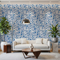 Blue floral vine wallpaper with large blooms and small rose buds.