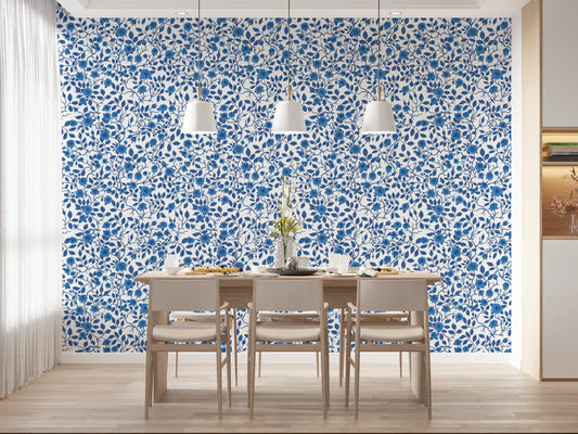 Cobalt blue rose wallpaper with layered leaves and curving stems in dining room.