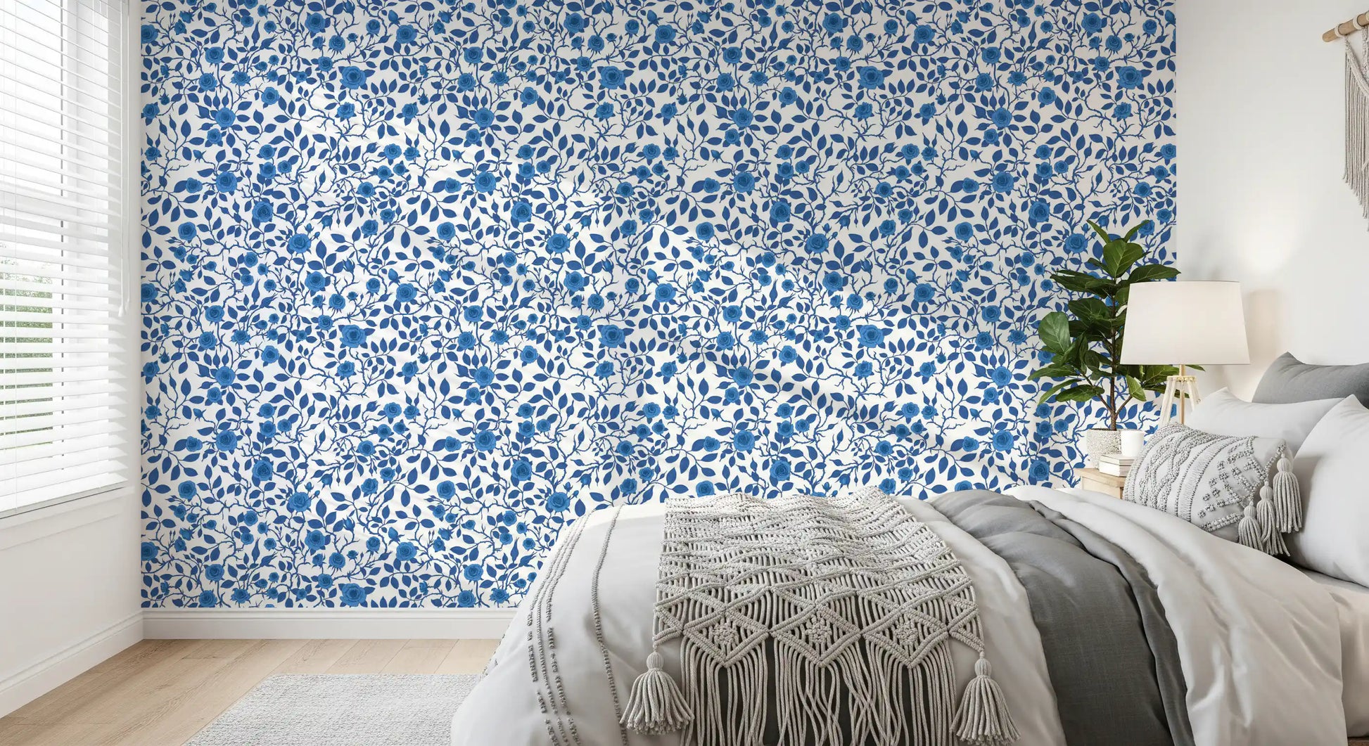 Bedroom wallpaper with blue roses and winding vine pattern on white.