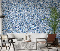 Living room wallpaper with monochrome blue rose floral repeat.