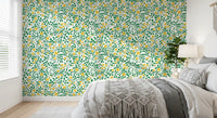 Bedroom wallpaper with yellow roses and green trellis vines on white.