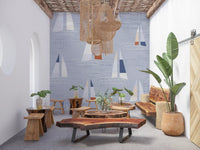 Coastal blue wall mural with scattered sailboat motifs and wave lines.