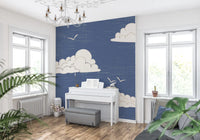 Blue wall mural with Curved bird outlines above white clouds.