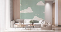 Wall mural showing light sage sky with white clouds and birds.