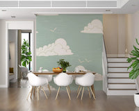 Mid century cloud and bird motif wall mural on sage ground in dining area.