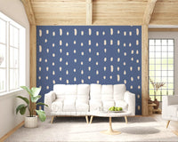 Cream seed-shaped dots scattered across dusty blue wall mural.