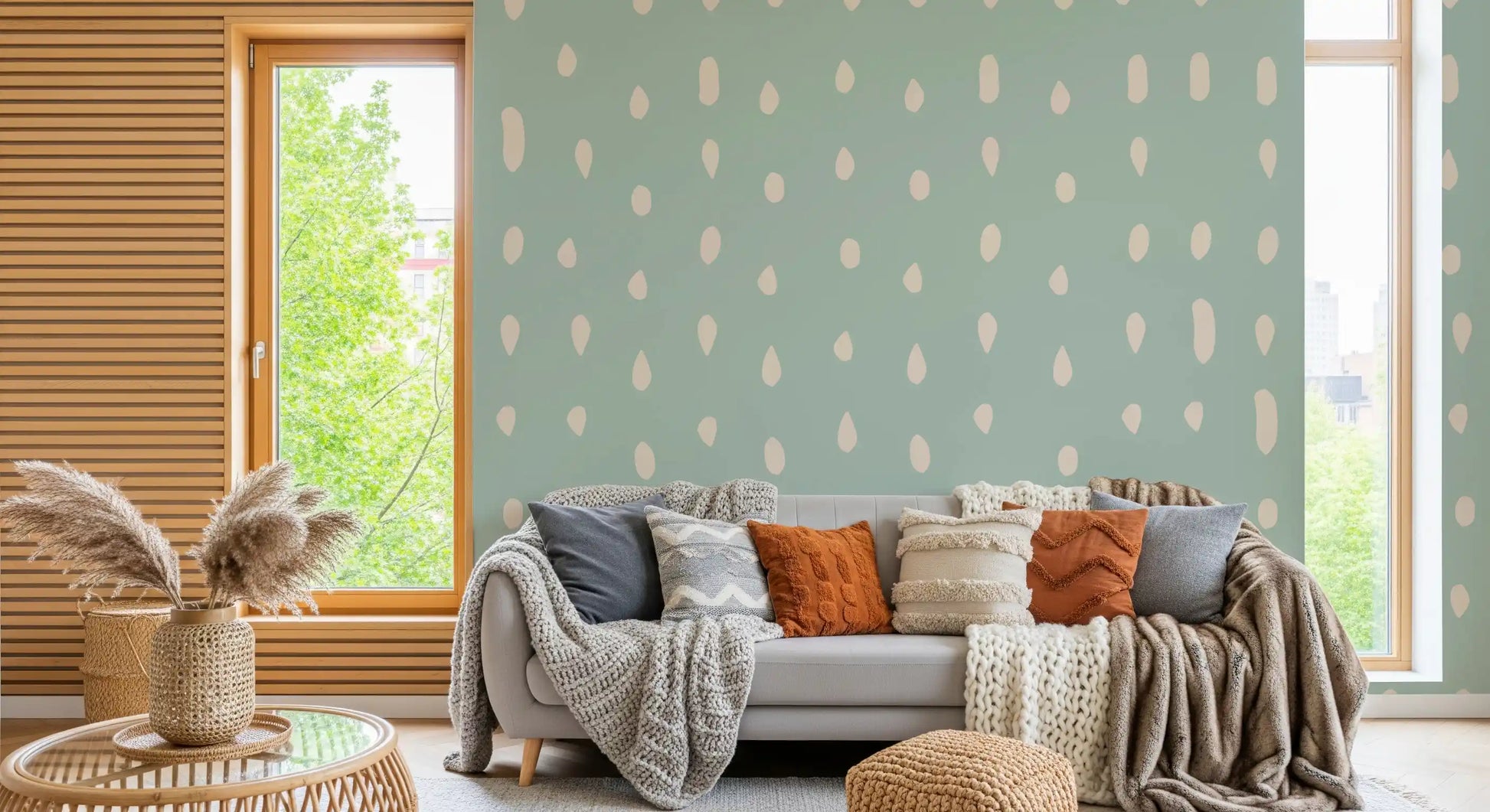 Cool sage wall mural with scattered cream seed shapes in living area., GD10571