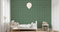 Dark green wavy lines on muted olive background wallpaper in bedroom.