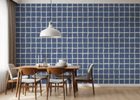 Wavy cream lines forming irregular grid on blue wallpaper.
