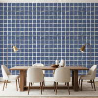 Dusty blue wavy grid wallpaper with cream irregular lines.
