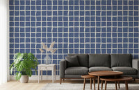 Cream wavy lines on muted blue background wallpaper in living room.
