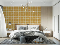Mid century mustard grid wallpaper with cream lines in bedroom.