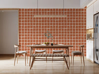 Warm terracotta wavy grid wallpaper with organic line spacing in dining area.