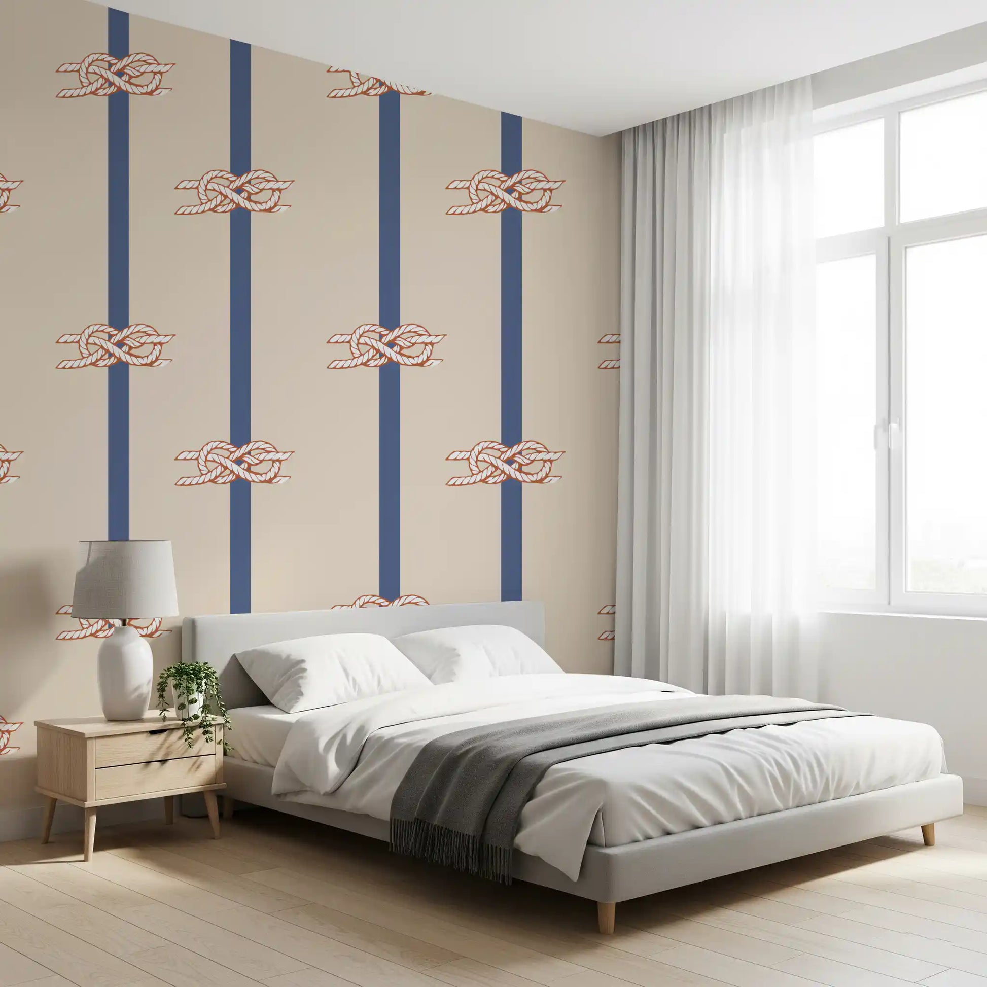 Beige and navy striped wallpaper with repeating nautical rope knot motifs in bedroom.