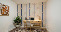 Navy vertical stripes with rope knot motifs on warm beige wallpaper.