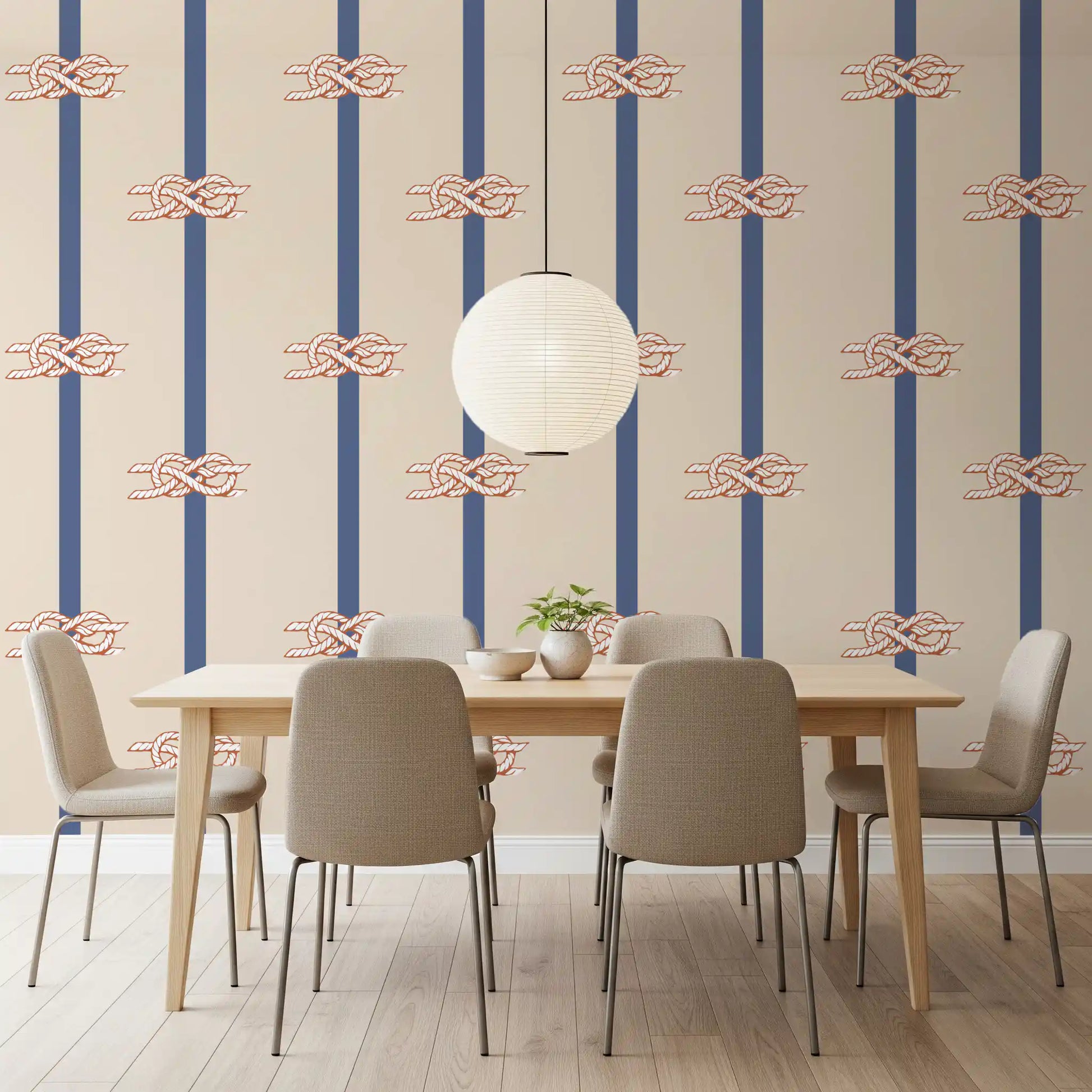 Terracotta and white sailor knots on beige and navy striped wallpaper.