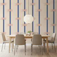 Terracotta and white sailor knots on beige and navy striped wallpaper.