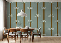 Sage green wallpaper with white sailor knots along olive brown stripe bands.