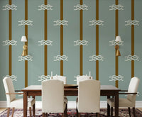 Sage green nautical wallpaper with rope knots in a dining room.