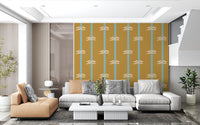 White sailor knots on mustard and sky blue striped wallpaper in living area.