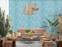 Vertical cascade of watercolour leaf marks on blue and teal wallpaper.