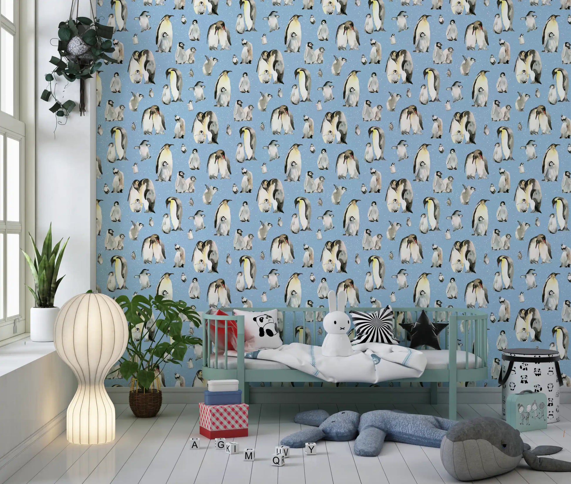 Emperor penguin family groups scattered across blue patterned wallpaper