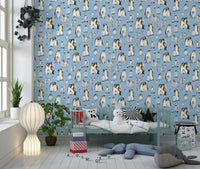 Emperor penguin family groups scattered across blue patterned wallpaper
