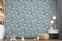Watercolour emperor penguins and chicks pattern on soft blue wallpaper.