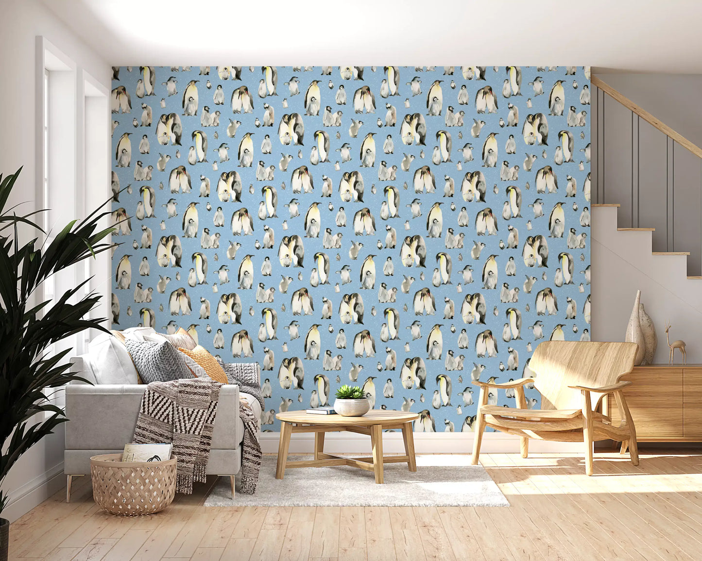 Baby penguin chicks huddled together on snowy blue repeat pattern wallpaper.