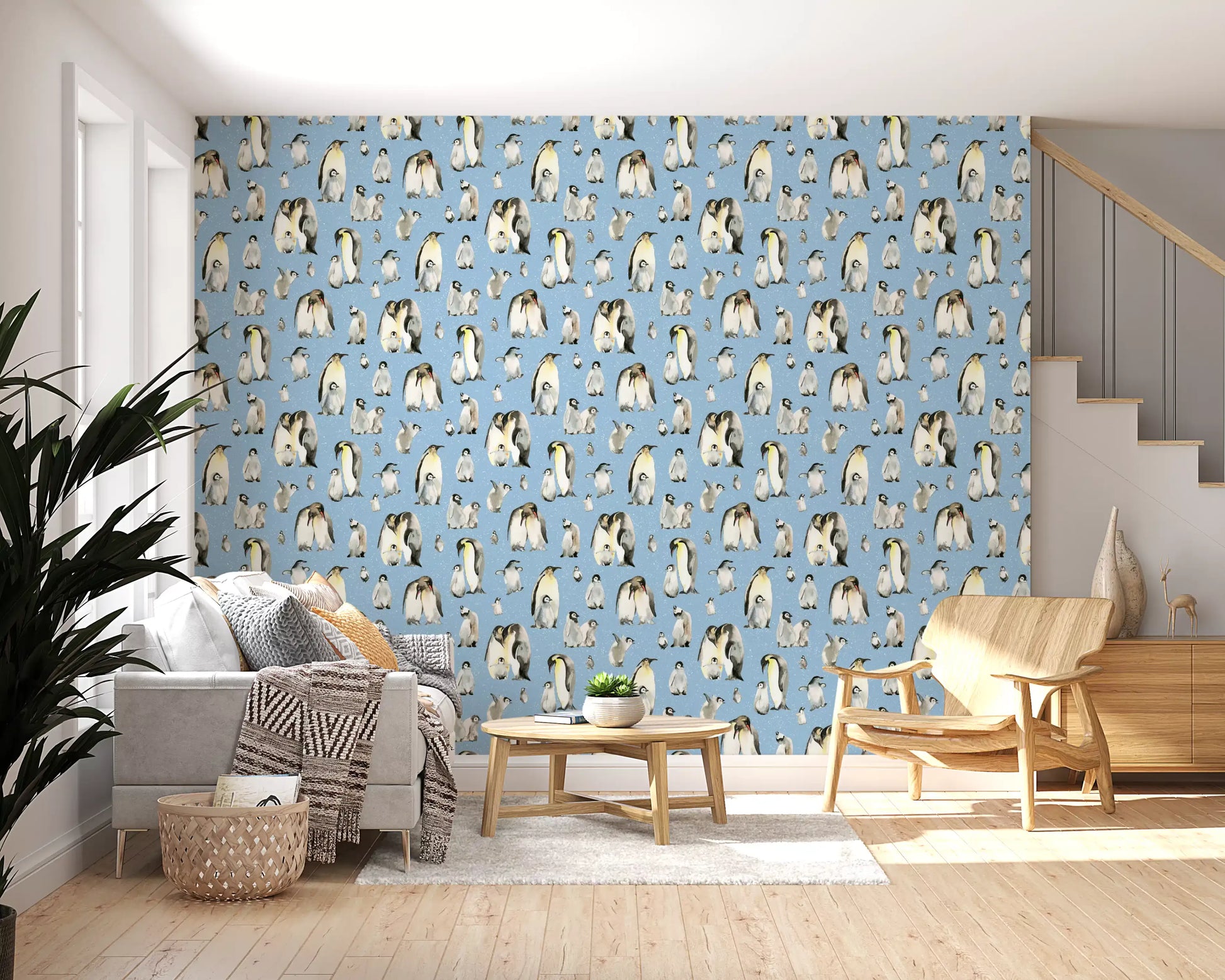 Baby penguin chicks huddled together on snowy blue repeat pattern wallpaper.