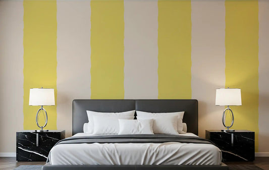Yellow and cream striped wallpaper displayed in a bedroom setting.