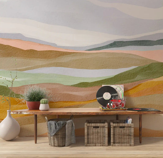 Hallway wall mural showing painted hills in green gold and terracotta.