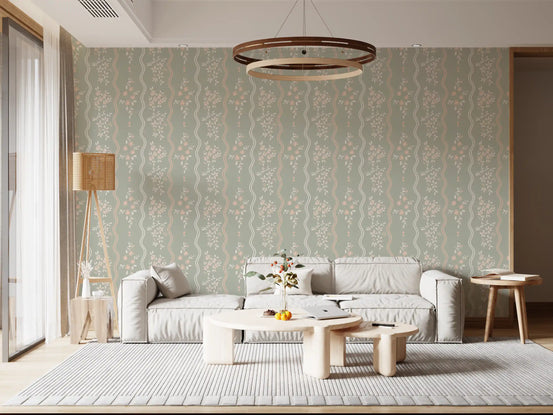 Blush pink blossoms and cream leaves on sage green wallpaper in living room. GD10742