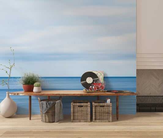 Calm blue seascape wall mural with ocean water below a hazy sky GD11268