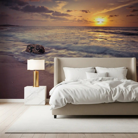 Sunset mural with a lone seaweed rock on the wet sandy beach GD11379