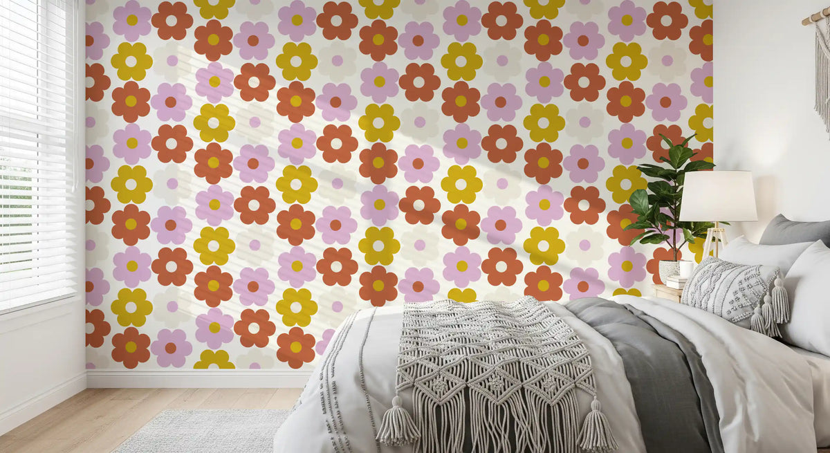 Retro floral wallpaper on a bedroom wall behind a bed with a macrame throw GD11923