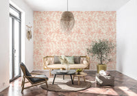 Blush floral wallpaper in a living room with rattan sofa GD12217