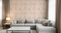 Pink botanical wallpaper in a warm living room with grey sectional GD12217