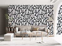 Monochrome pebble abstract wallpaper behind a sofa in a modern living room GD12223
