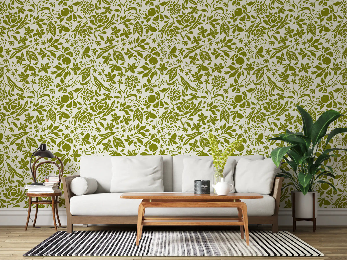 Green botanical wallpaper in a living room behind a white sofa and wood table GD12255