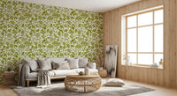 Green botanical silhouette wallpaper in a cosy living room with a beige sofa GD12255