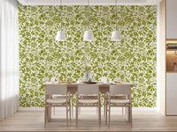 Sage botanical wallpaper in a bright dining room with a white table GD12255