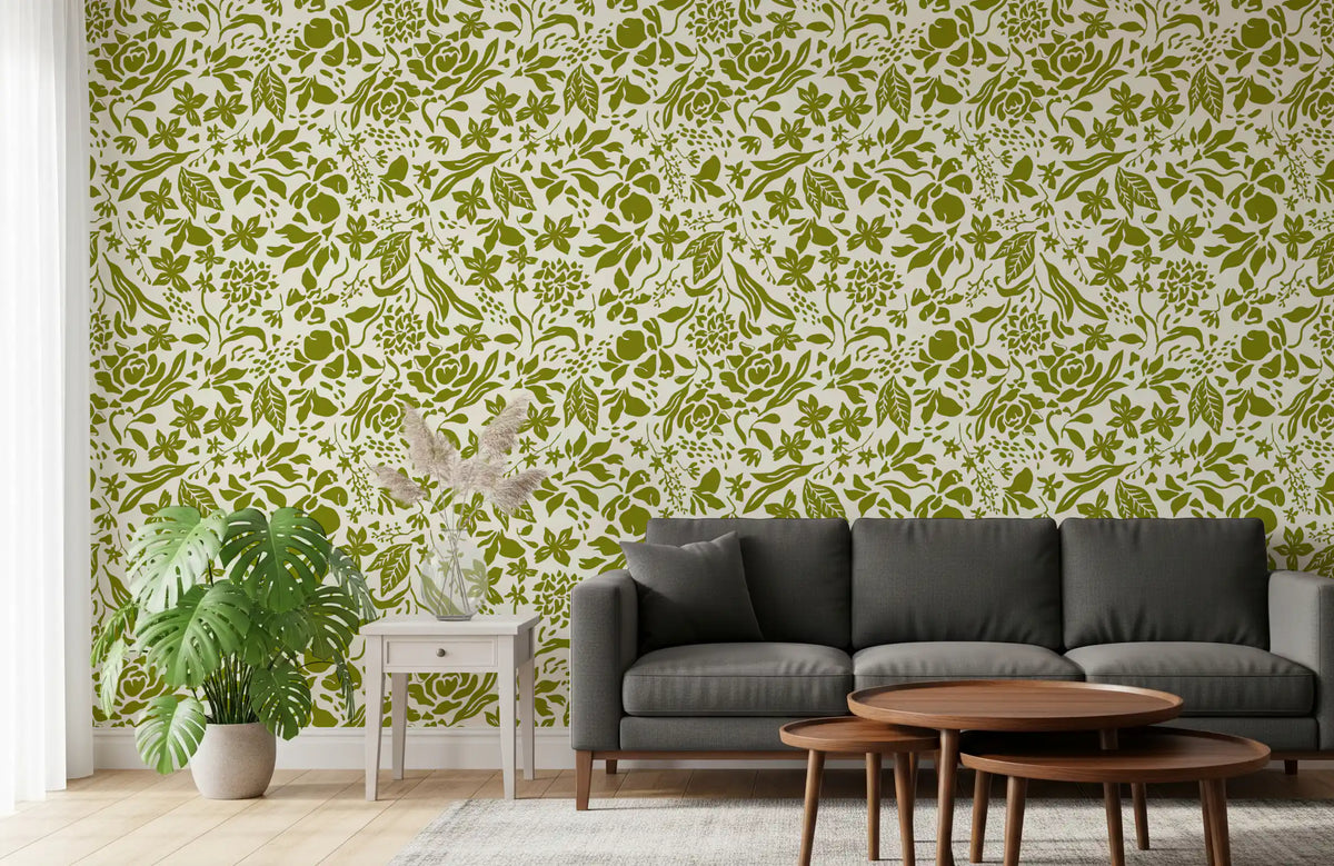 Green botanical silhouette wallpaper in a living room with a black sofa and plants GD12255