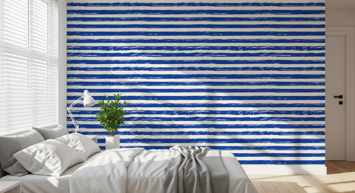 Blue striped wallpaper behind a bed in a calm bedroom GD12267