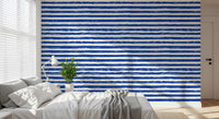 Blue striped wallpaper behind a bed in a calm bedroom GD12267