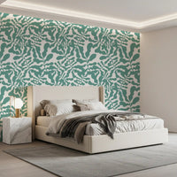 Sage green botanical wallpaper behind a bed GD12272
