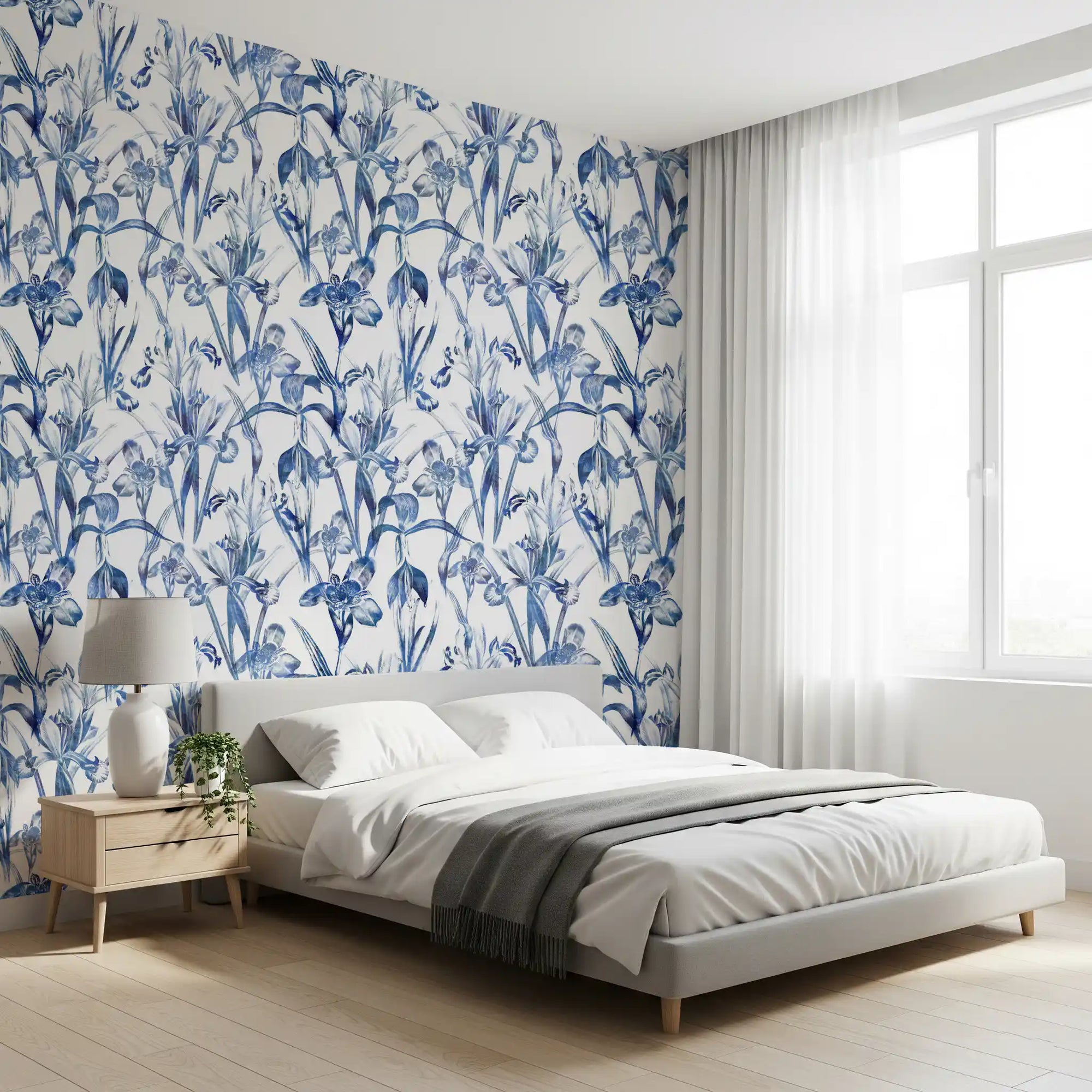 Blue and white botanical wallpaper in a calm bedroom with a wood nightstand GD12287