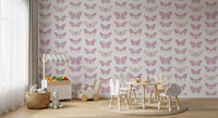 Pink butterfly wallpaper in a kids room with a play table and toy trolley GD12294