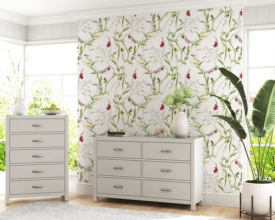 Wildflower meadow wallpaper in a bedroom with a white dresser and plants GD12301