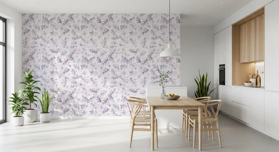 Lavender leaf wallpaper on a dining room wall with a wood table and plants GD12335
